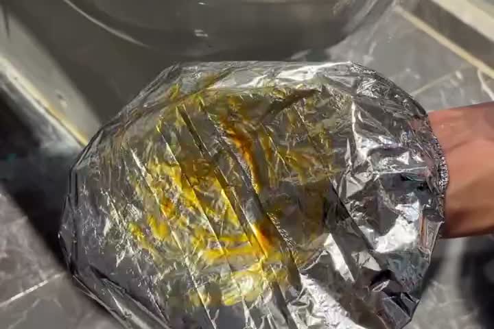 A FoilCover being rinsed under running water